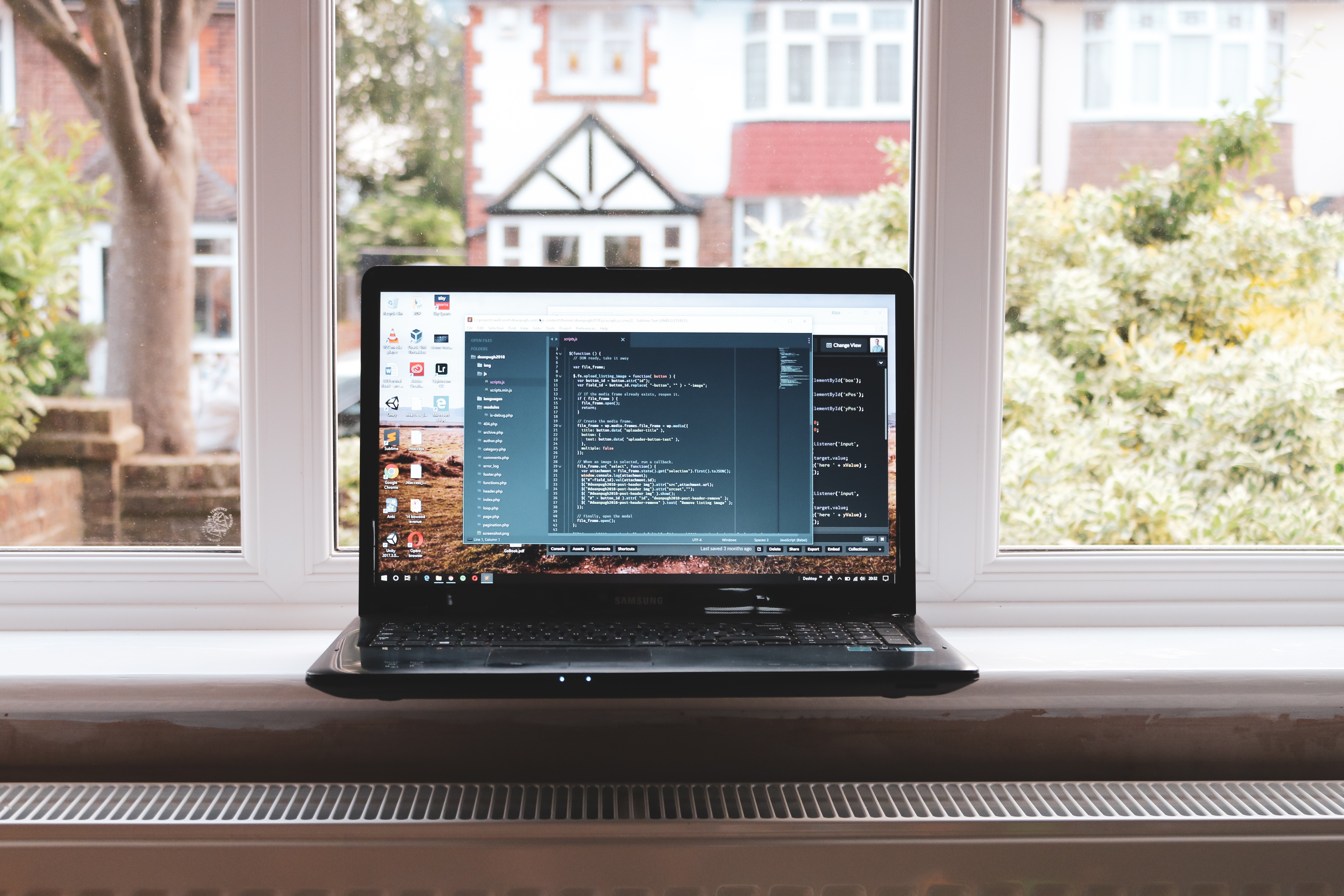 laptop coding on table